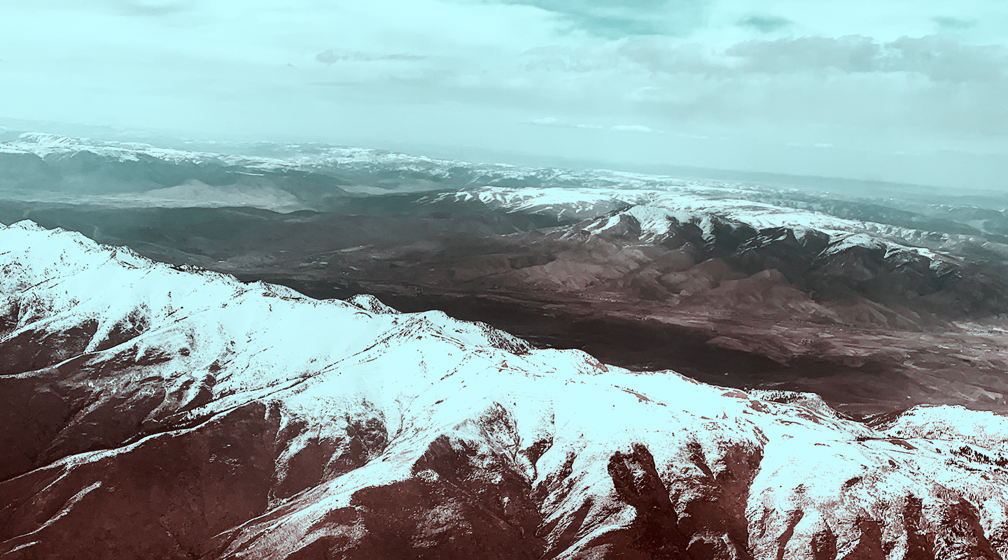 Out the window of a plane over the mountains flying into Salt Lake City, Utah. Copyright Lauren Ferrett 2021